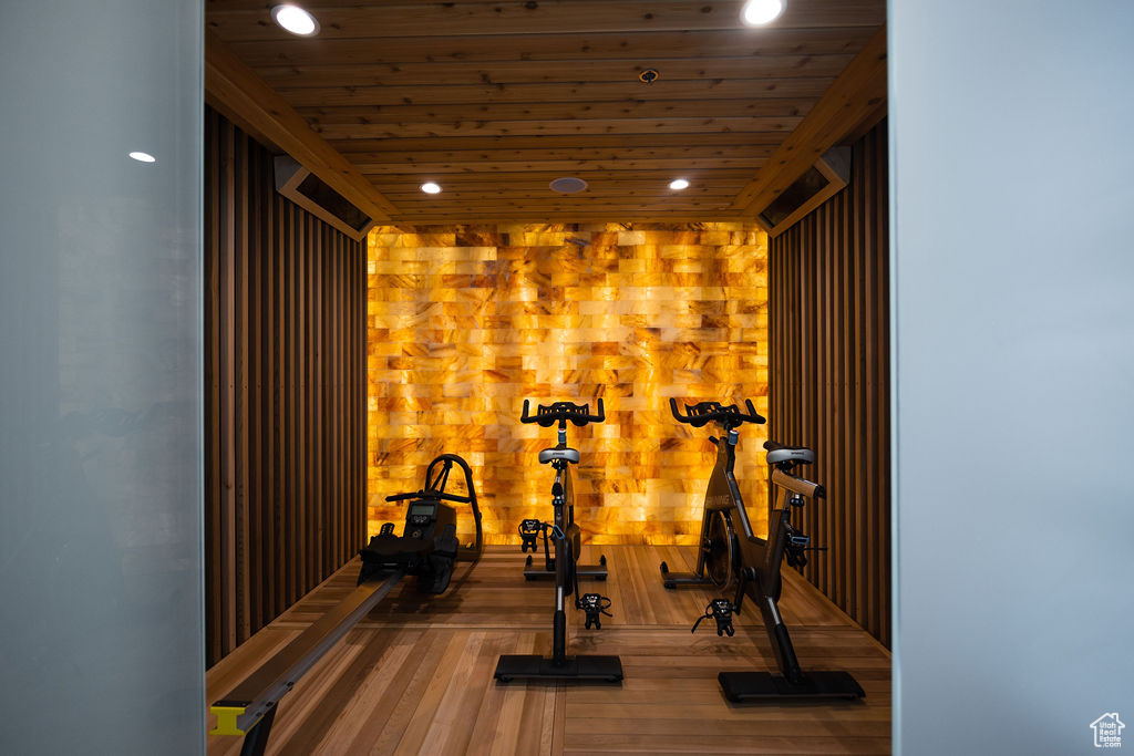 Exercise room with wood ceiling, recessed lighting, and wood finished floors