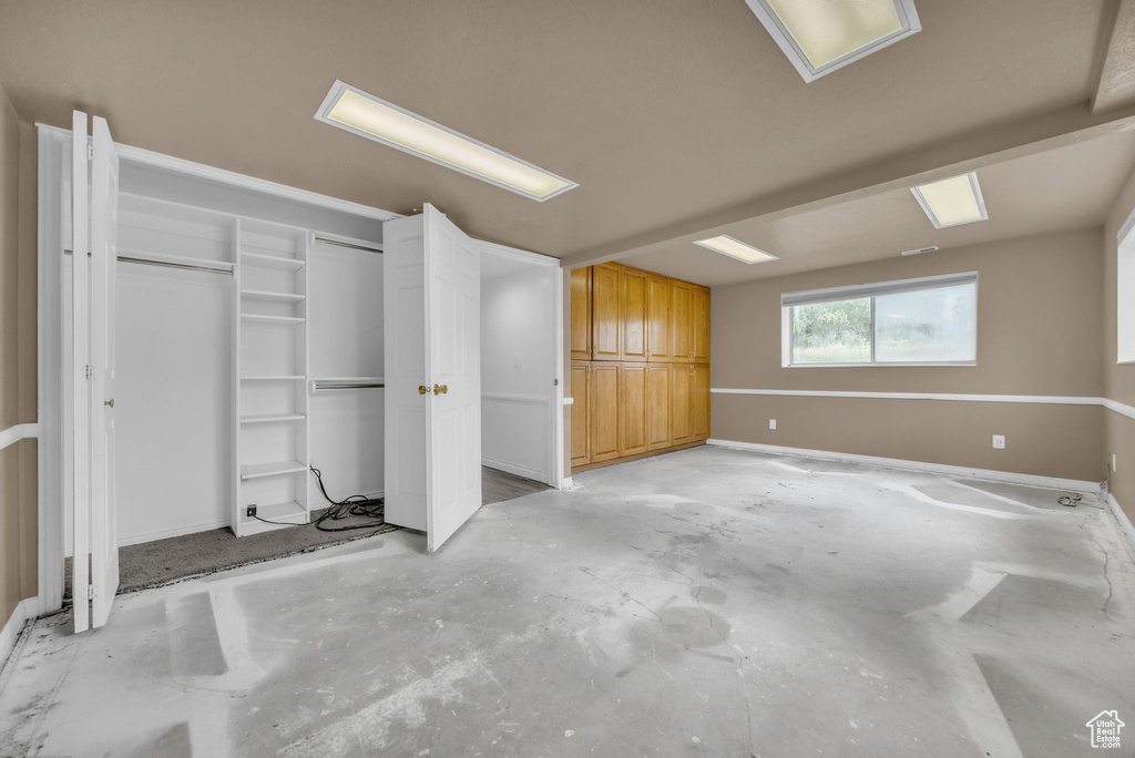 Unfurnished bedroom featuring baseboards and unfinished concrete floors