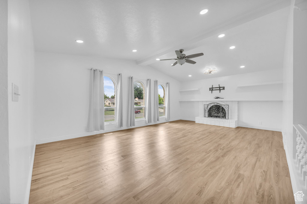 Unfurnished living room with a ceiling fan, light wood finished floors, a brick fireplace, and recessed lighting