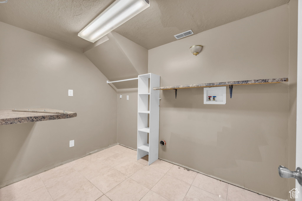 Walk in closet featuring light tile patterned floors