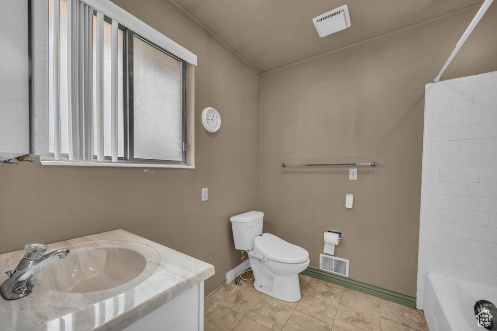 Bathroom featuring vanity, tile patterned flooring, and shower / bathtub combination