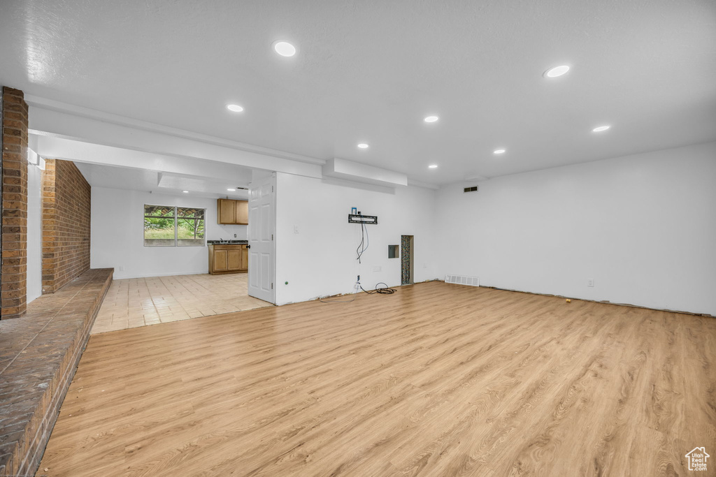 Unfurnished living room with light wood-style flooring and recessed lighting