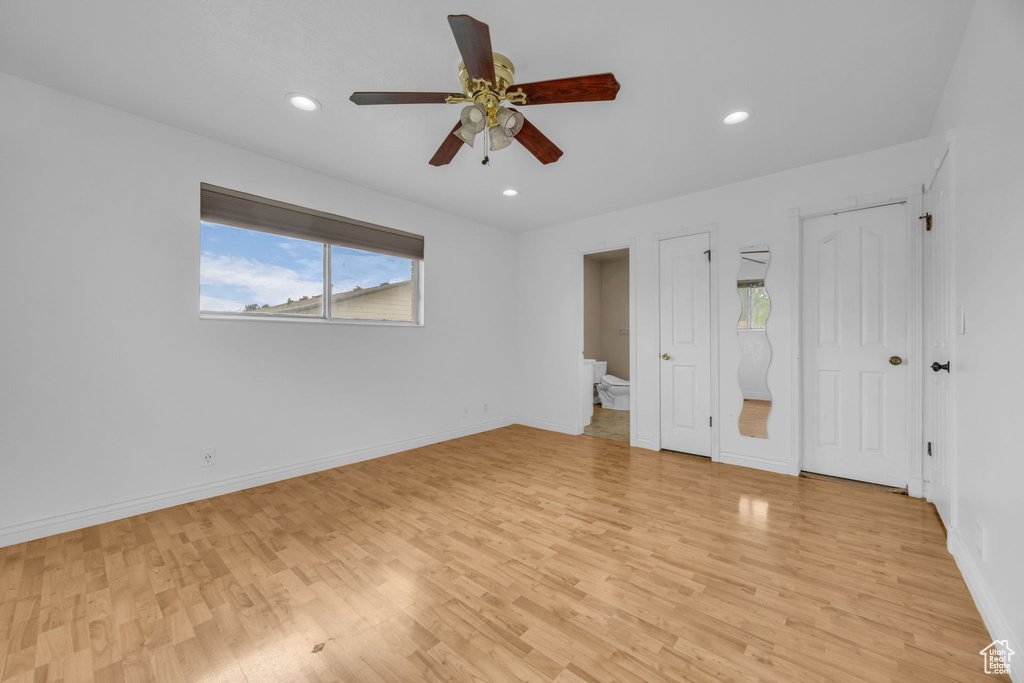 Unfurnished bedroom featuring light wood-type flooring, recessed lighting, ensuite bath, and a ceiling fan