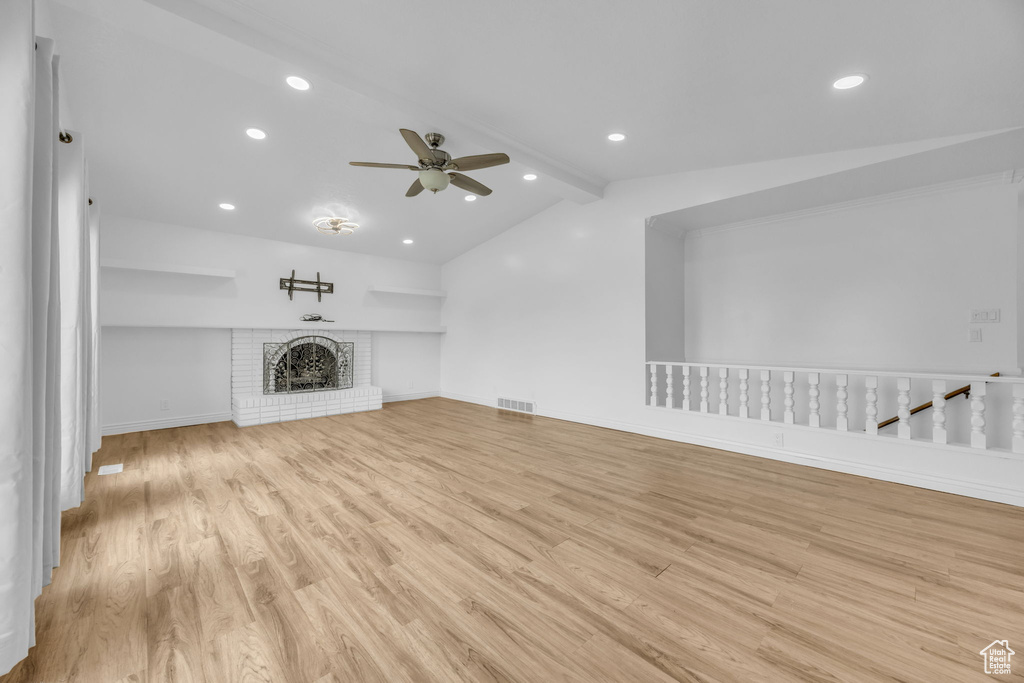 Unfurnished living room with a ceiling fan, light wood-type flooring, recessed lighting, and a fireplace