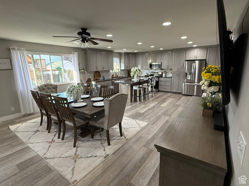 Dining area with light wood finished floors, recessed lighting, and ceiling fan