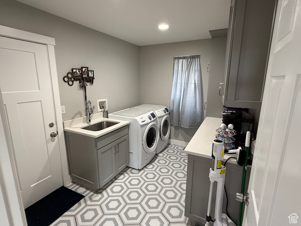 Laundry area featuring washer and clothes dryer, recessed lighting, cabinet space, and light flooring