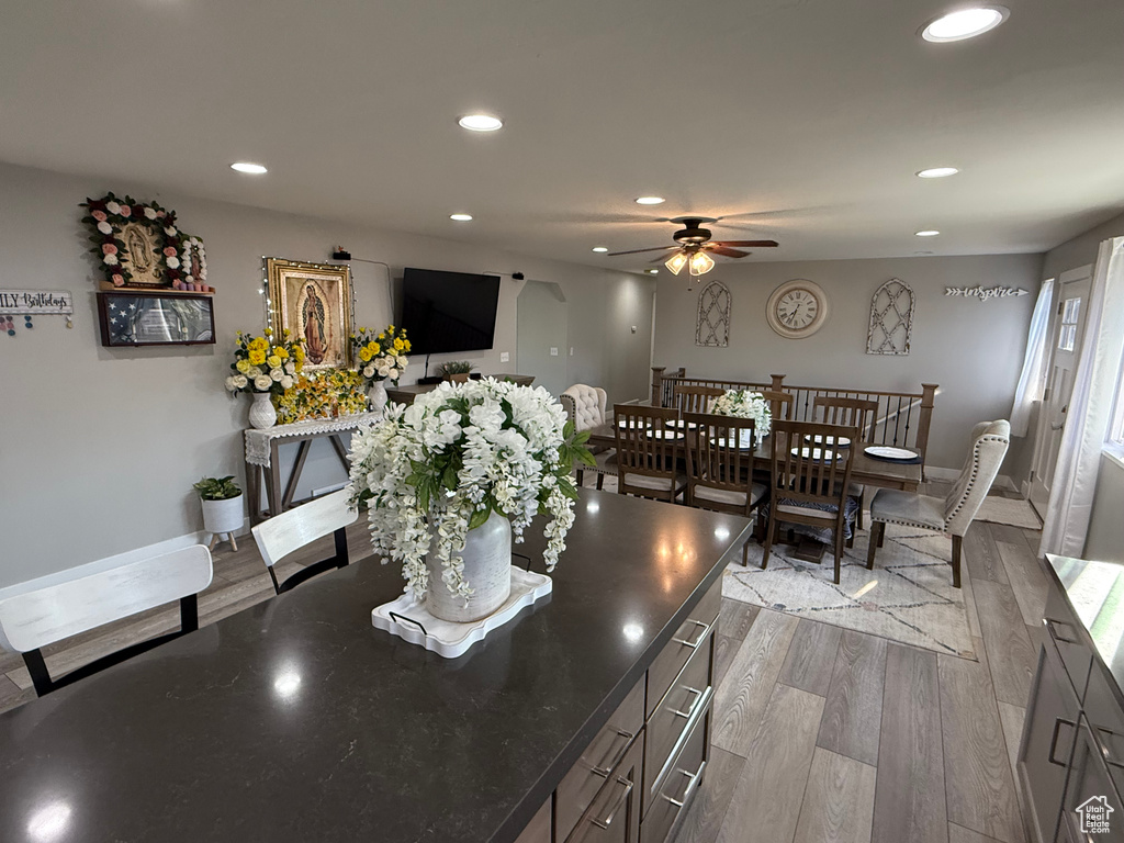 Dining area featuring wood finished floors, a ceiling fan, and recessed lighting
