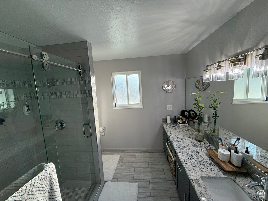 Bathroom with double vanity and a shower stall