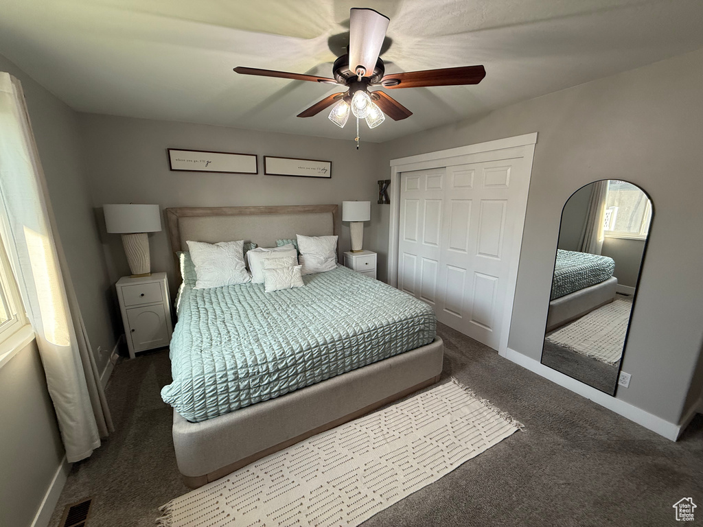 Bedroom with carpet floors, a closet, and ceiling fan