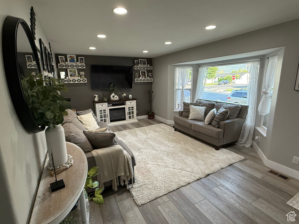 Living room with recessed lighting and wood finished floors