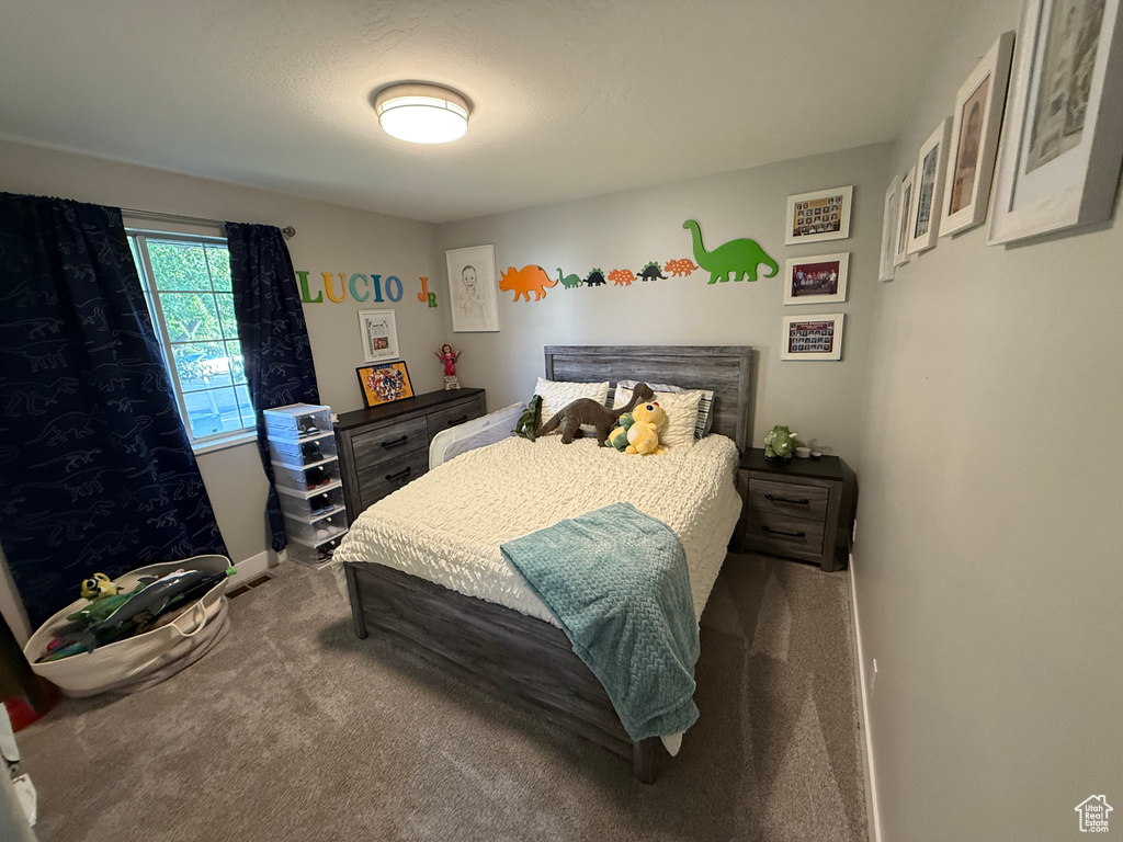 Carpeted bedroom featuring baseboards