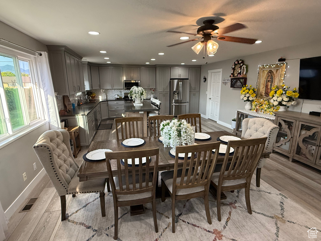 Dining room with light wood-style flooring, recessed lighting, and ceiling fan