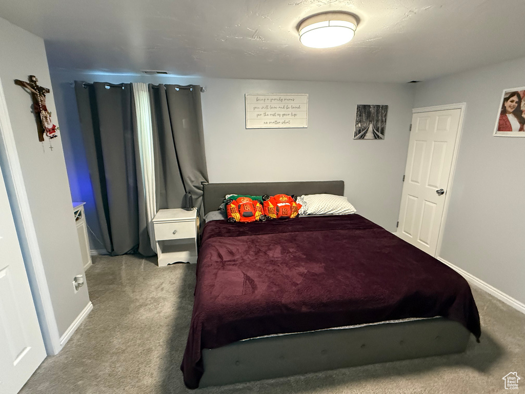 Carpeted bedroom with baseboards