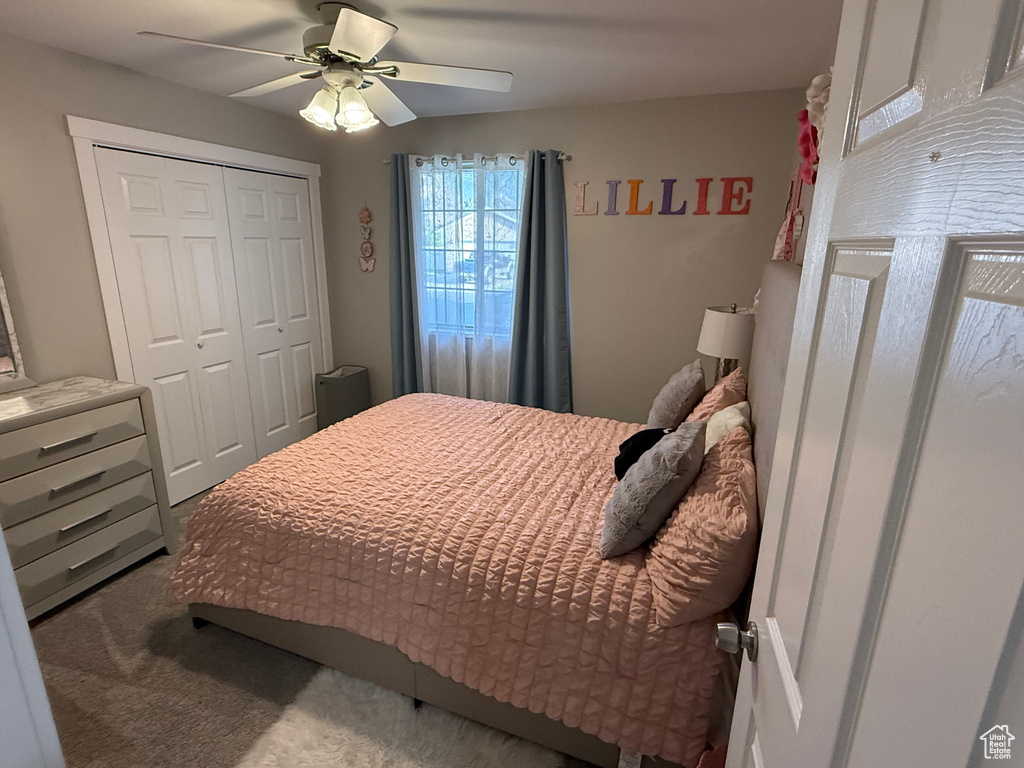Bedroom featuring a closet, a ceiling fan, and carpet