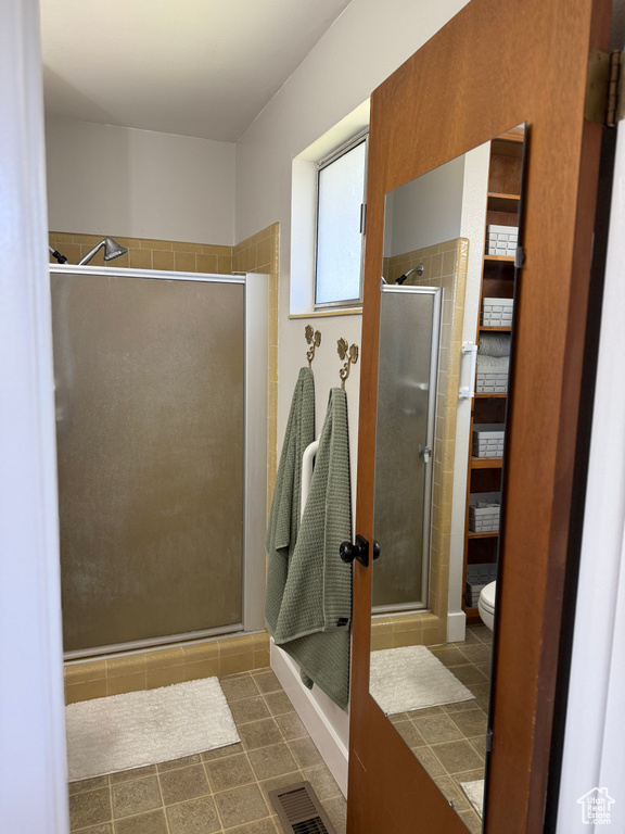Bathroom featuring a stall shower and tile patterned flooring
