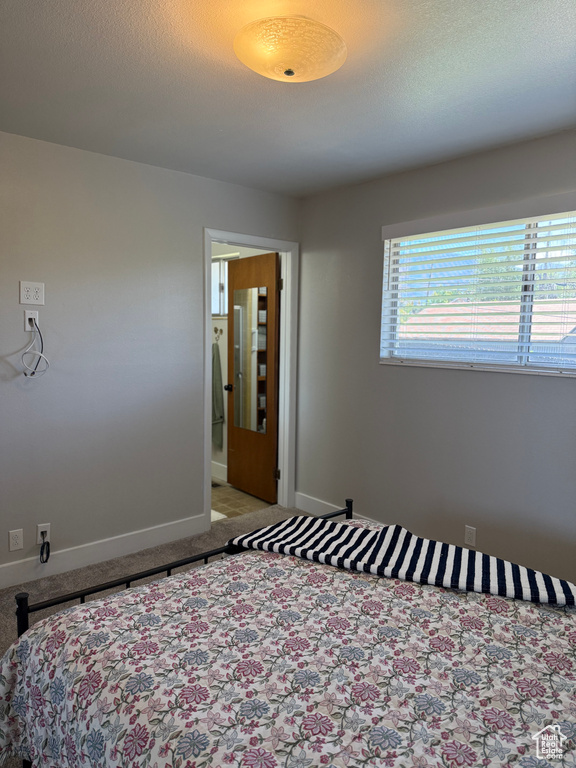 Bedroom featuring light carpet