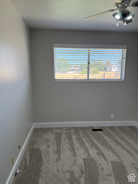 Unfurnished room featuring carpet floors and ceiling fan
