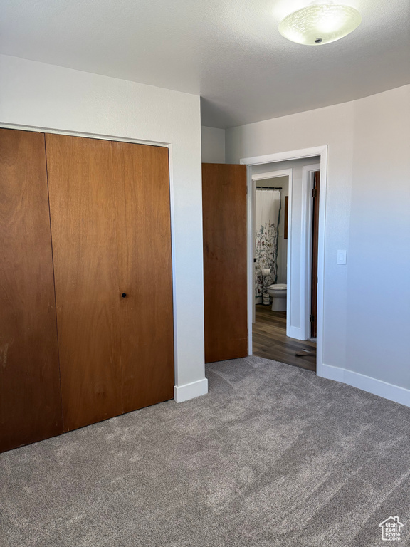 Unfurnished bedroom with carpet flooring and a closet