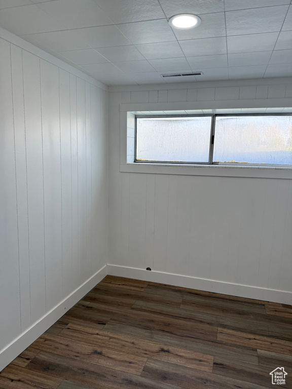 Empty room with dark wood-style floors and baseboards