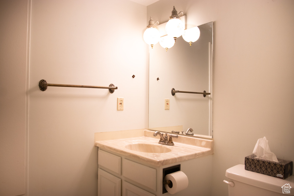 Half bath featuring toilet and vanity