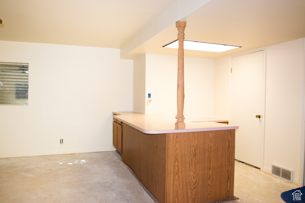 Indoor dry bar featuring concrete floors