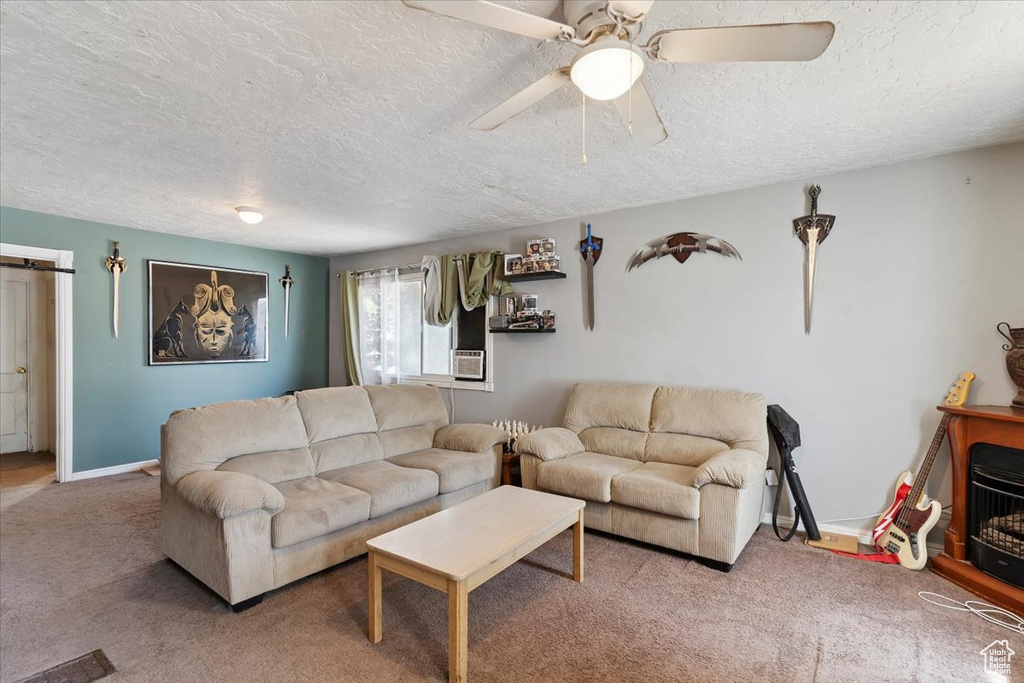 Carpeted living room featuring a textured ceiling and ceiling fan