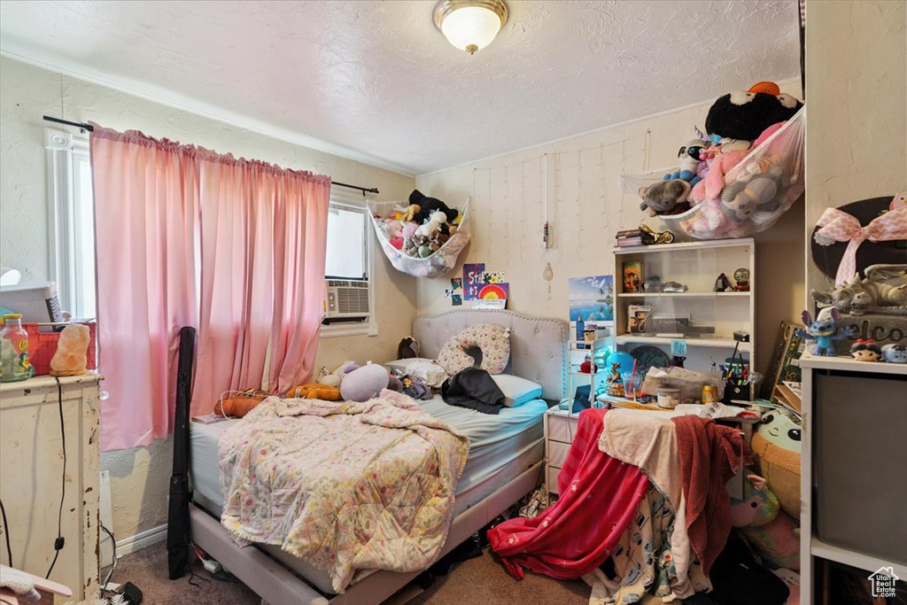 Bedroom featuring a textured ceiling and cooling unit