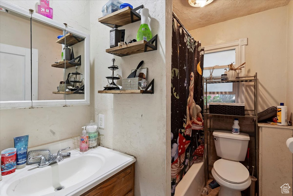 Bathroom featuring vanity and shower / tub combo with curtain