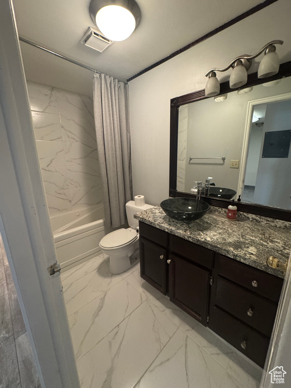Full bathroom with marble look tiles, vanity, and shower / bathtub combination with curtain