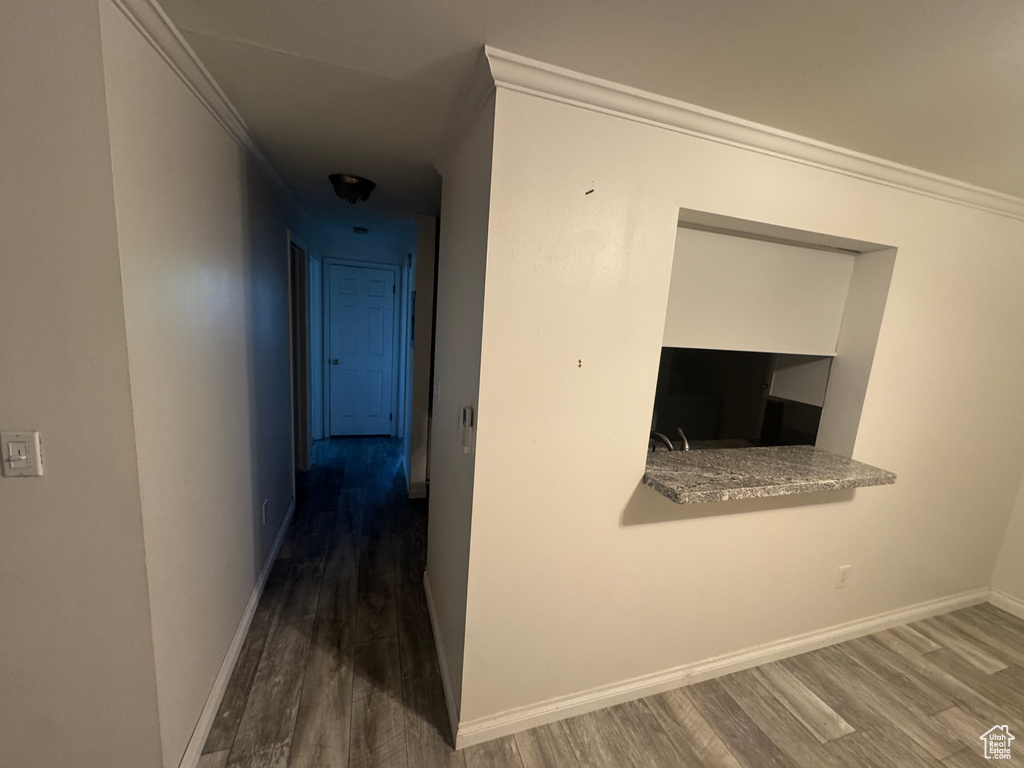 Hall featuring wood finished floors and ornamental molding