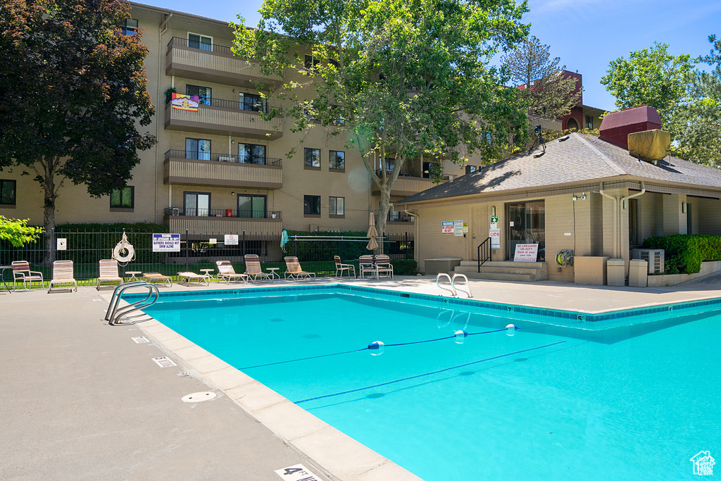 Community pool with a patio