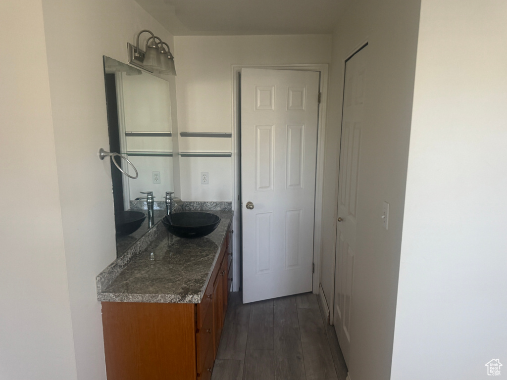 Bathroom with vanity and wood finished floors
