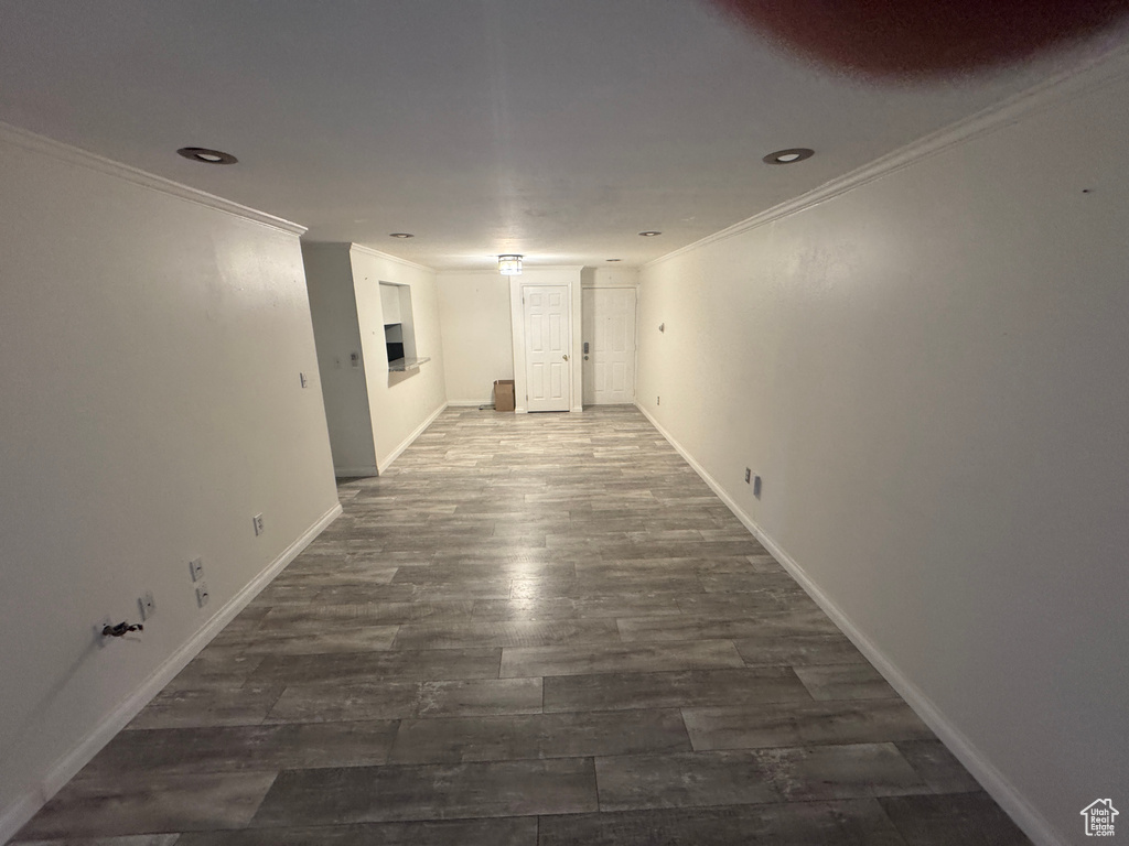 Hallway featuring ornamental molding, dark wood-style floors, and recessed lighting