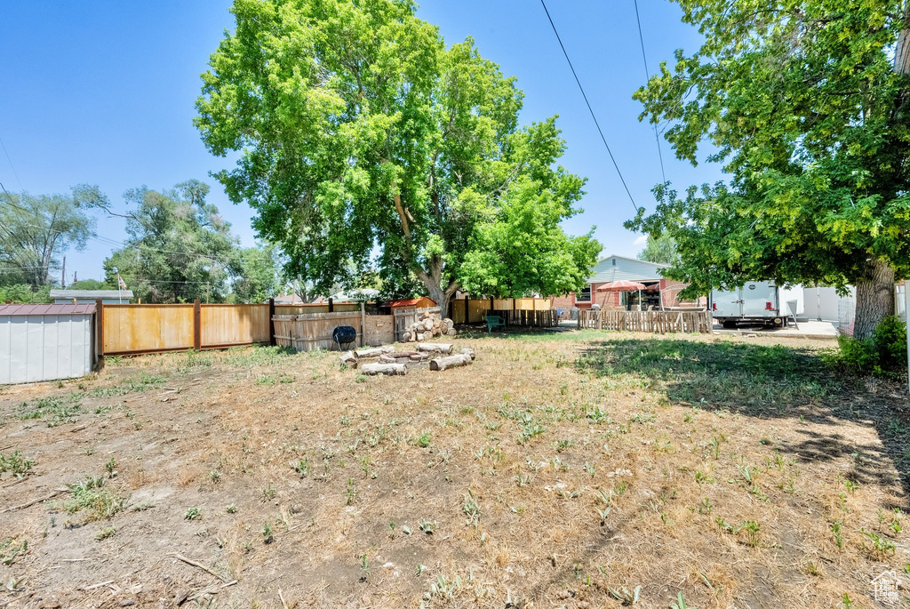 Fenced backyard with a storage unit