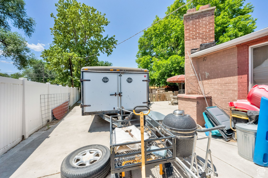 Fenced backyard featuring a patio area and a storage shed