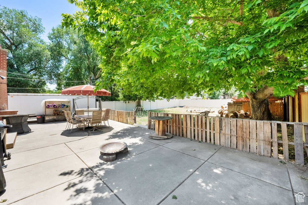 Fenced backyard with a patio and outdoor dining area