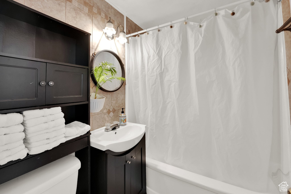 Full bath featuring vanity and shower / bath combo with shower curtain