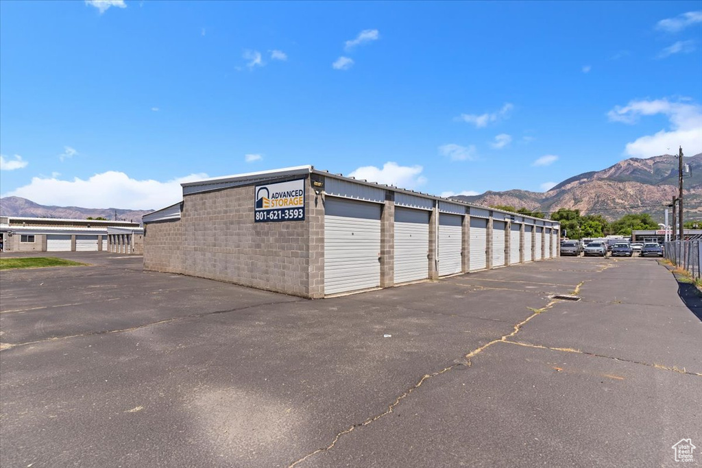 View of building exterior with a mountain view and community garages