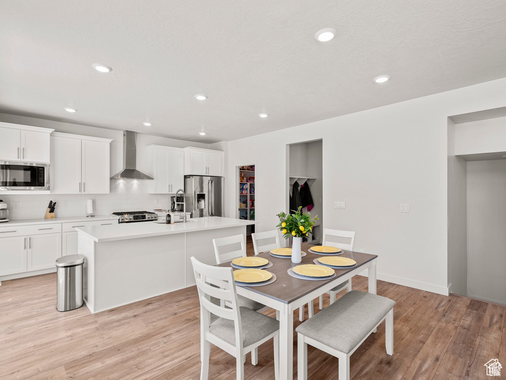 Dining space featuring light wood finished floors and recessed lighting