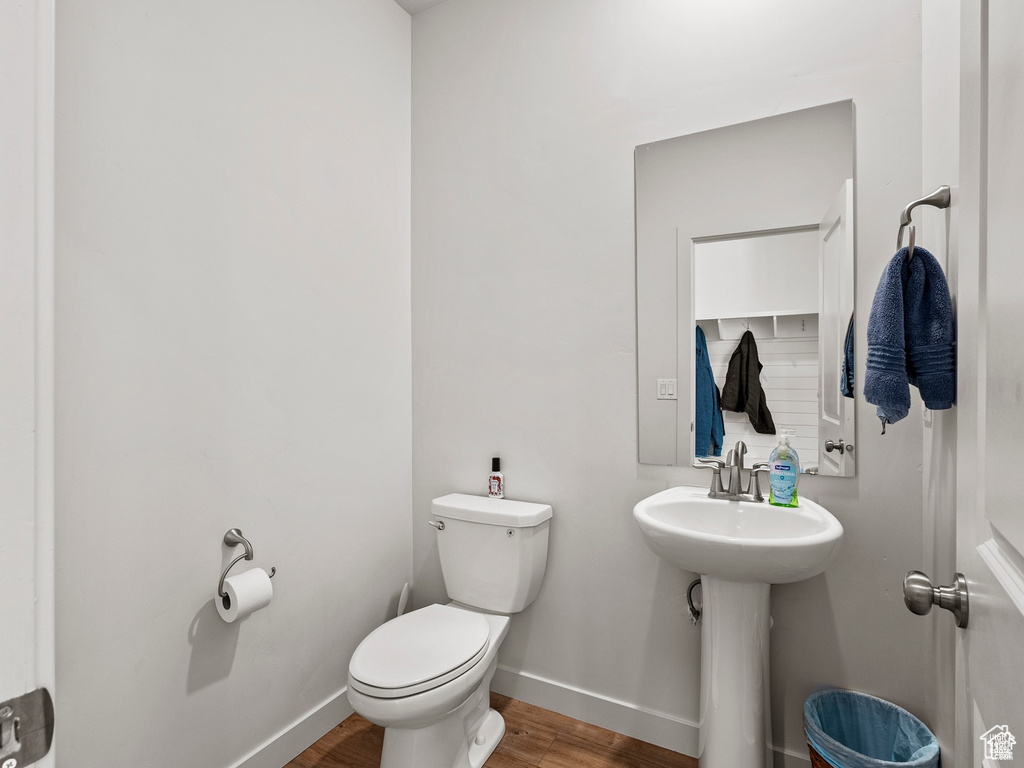 Bathroom with toilet and wood finished floors