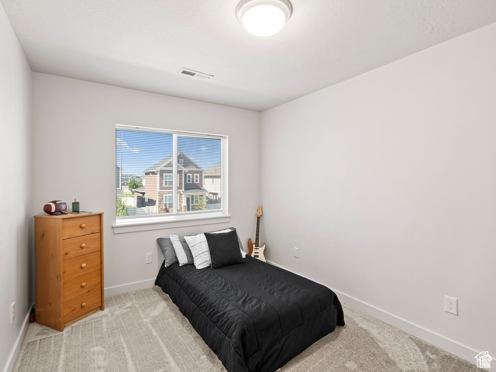 Carpeted bedroom featuring baseboards