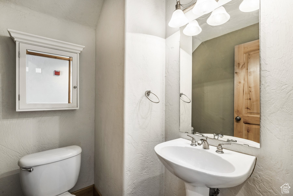 Half bath with a sink and toilet