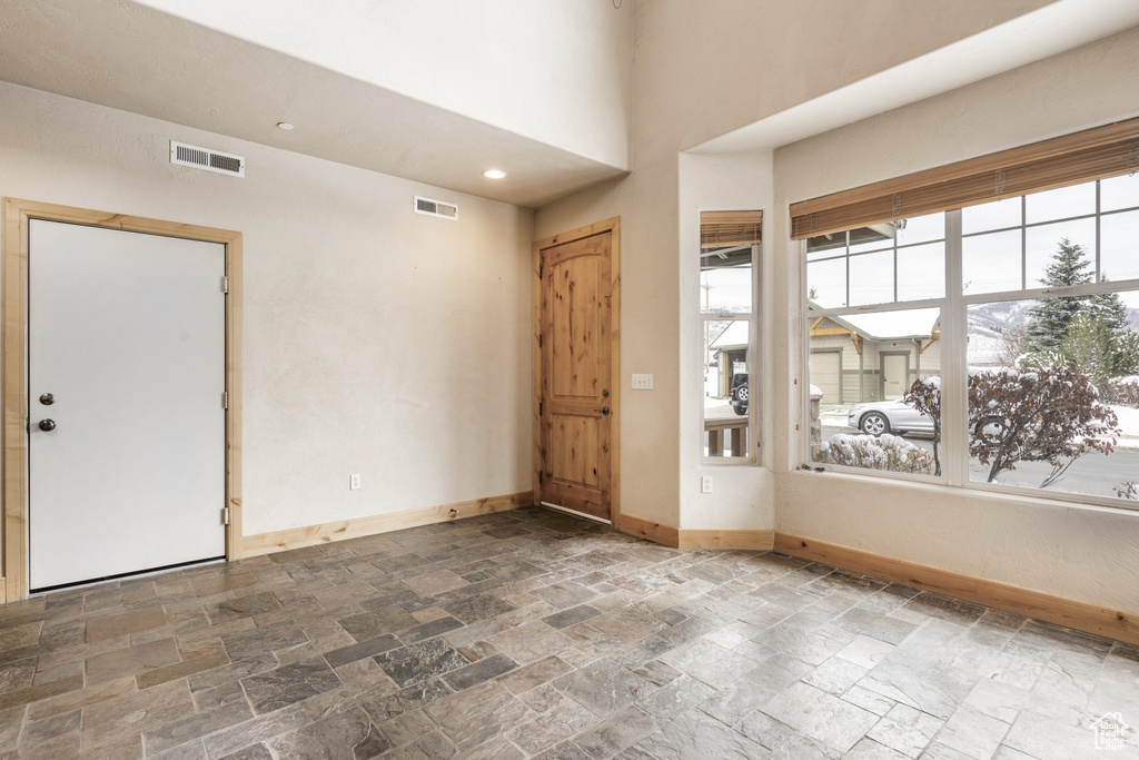Entryway featuring stone tile floors and baseboards