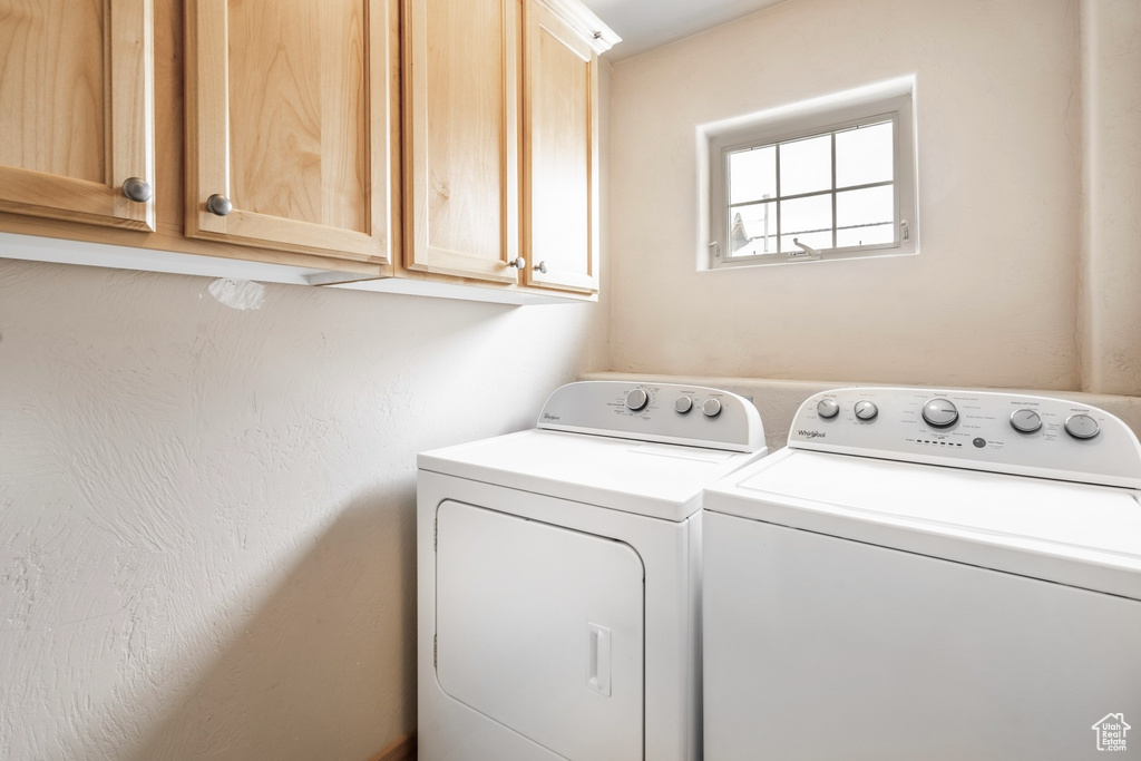Laundry area with washer and clothes dryer and cabinet space