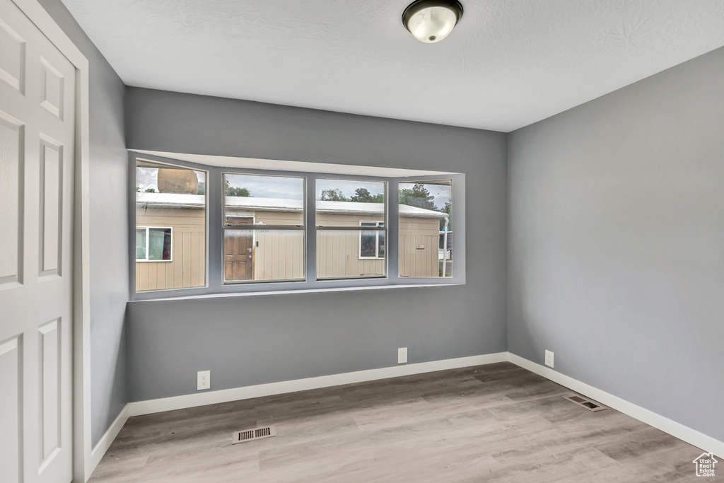 Unfurnished room with wood finished floors