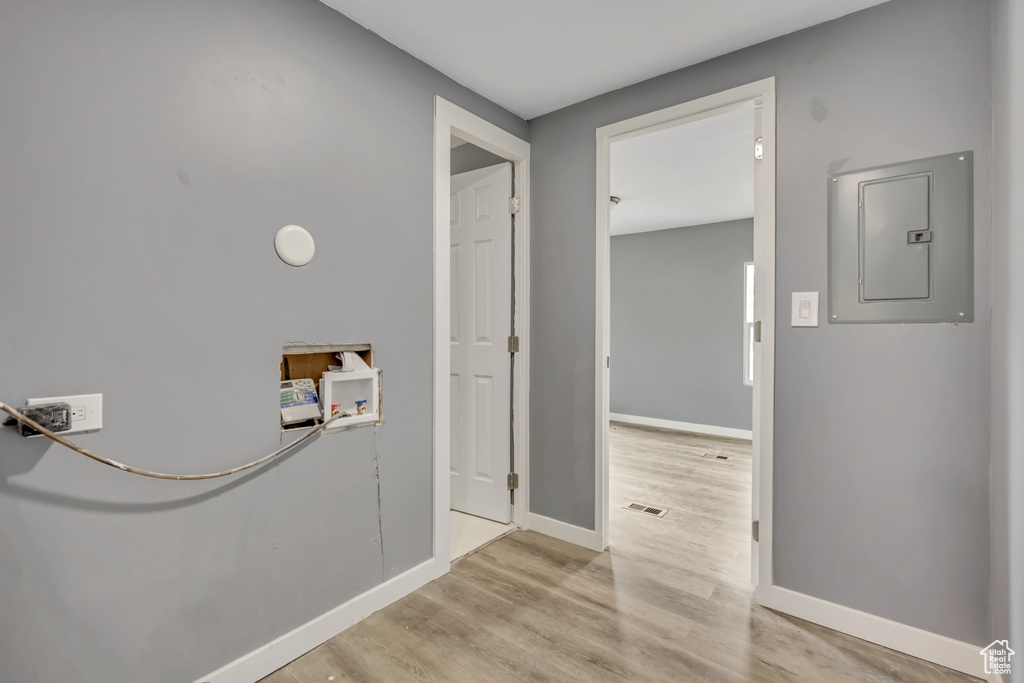 Hallway featuring electric panel and wood finished floors