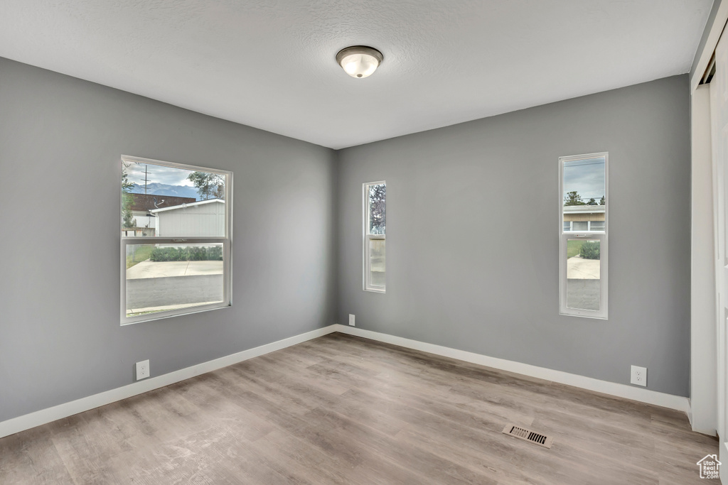 Spare room with wood finished floors