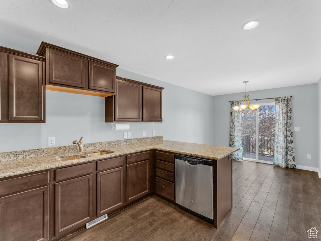Kitchen featuring dishwasher, a chandelier, dark wood finished floors, a peninsula, and recessed lighting