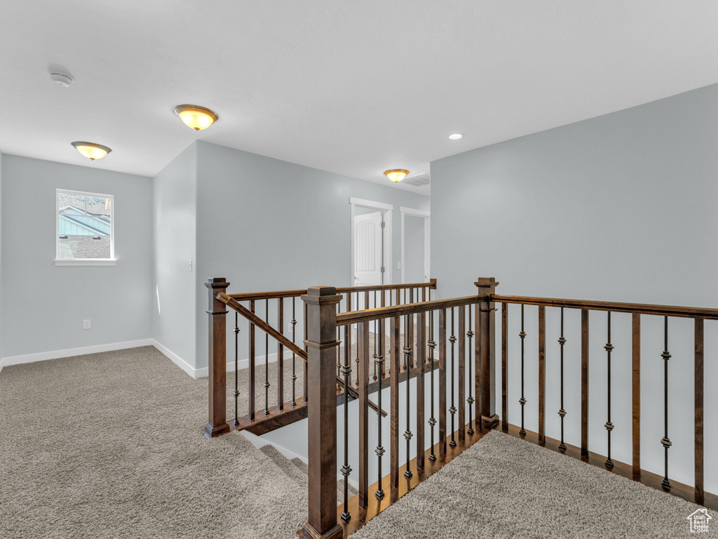 Corridor with carpet flooring, an upstairs landing, and recessed lighting
