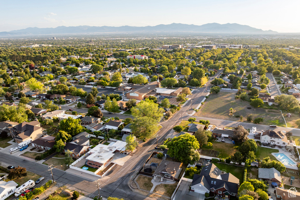 Aerial view of property's location featuring mountains and nearby suburban area